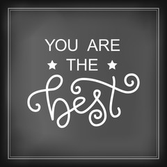 Modern calligraphy lettering of You are the best in white on blackboard background stylized as chalk lettering for decoration, design, sticker, logo, stamp, postcard, greeting card, gift tag, poster