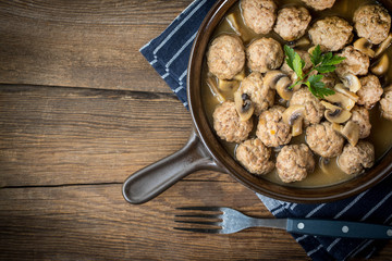 Delicious homemade swedish meatballs with mushroom cream sauce. Small depth of field. Top view.