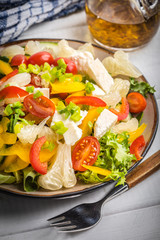 Salad with cheese and fresh vegetables.