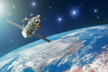 Spaceship piloted by astronauts in the orbit of planet Earth with bright stars. Elements of this image furnished by NASA.