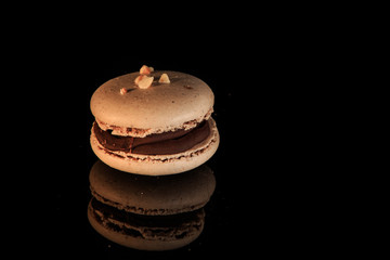 closeup beige peanut macaron with chocolate filling