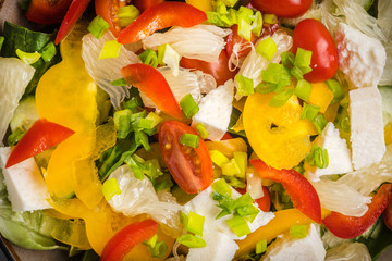 Salad with cheese and fresh vegetables.