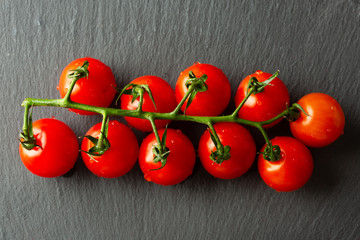 Top view of the small branch of fresh cherry tomatoes branch