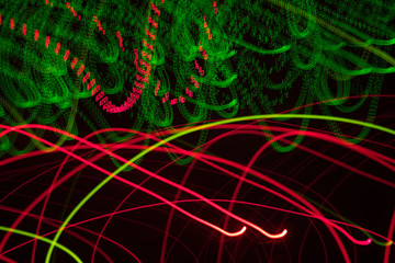 abstract light effect with chaotic red and green lines. Dark futuristic background.
