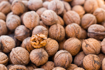 Walnut kernels on natural walnut pattern background, Raw bio walnuts texture, top view