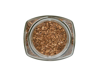 Glass jar filled with instant, granulated coffee the top view on a white background