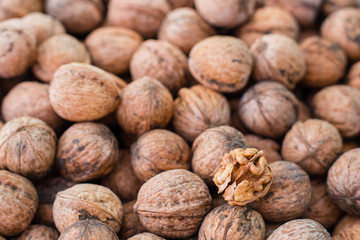 Walnut kernels on natural walnut pattern background, Raw bio walnuts texture, top view