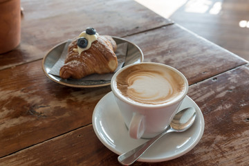Croissant and cappuccino for breakfast