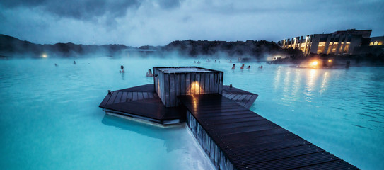 Reykjavik, Iceland - July 4, 2018: Beautiful geothermal spa pool in Blue Lagoon in Reykjavik. The Blue Lagoon geothermal spa is one of the most visited attractions in Iceland. - obrazy, fototapety, plakaty