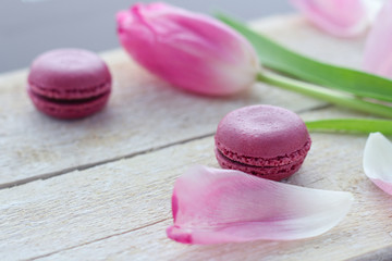 romantic delicate composition with pink flowers and macaroon cakes.