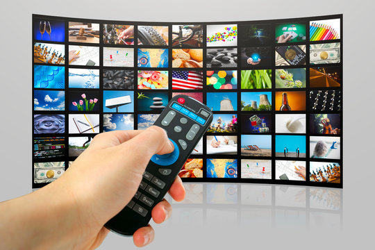 TV with pictures of smart television and man's hands with remote control,close up.