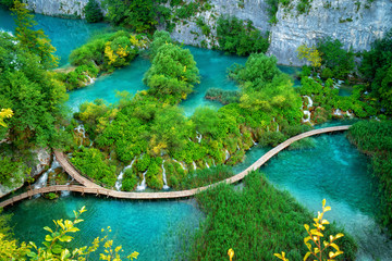 Beautiful wooden path trail for nature trekking with lakes and waterfall landscape in Plitvice Lakes National Park, UNESCO natural world heritage and famous travel destination of Croatia. © InfiniteFlow