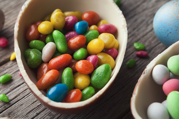 Half of chocolate egg filled with colorful candies