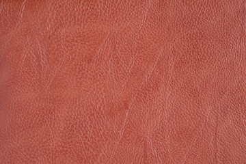 The texture of the material of leather brown, close-up.
