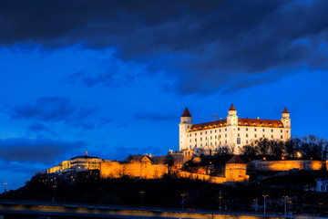 night view of Bratislava castle from river surface with dramtic sunset skyline