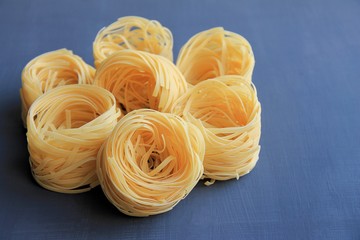 no boiled macaroni nests on blue background