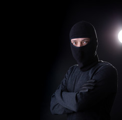 Robber in bachelor with arms crossed.