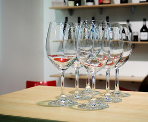Glasses of wine. Glasses hanging above the bar in the restaurant. Empty glasses for wine