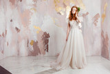 Elegant red-haired girl bride. Young beautiful woman in wedding dress