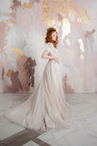 Elegant red-haired girl bride. Young beautiful woman in wedding dress