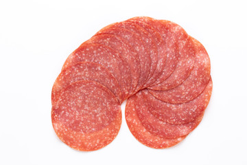 Salami slices on white background.