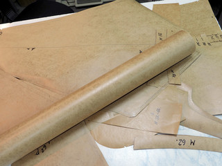 roll of drawing paper and patterns on the table