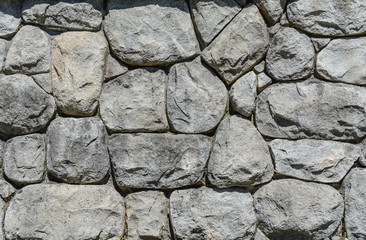 Grey stones in wall texture background. Modern building material