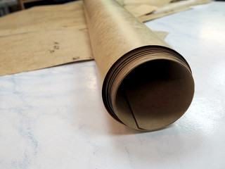 roll of drawing paper and patterns on the table