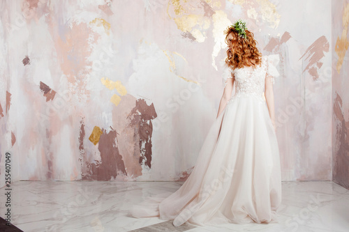 Elegant red-haired girl bride. Young beautiful woman in wedding dress