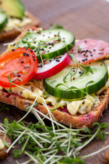 Sandwiches with cream cheese, vegetables and salami.