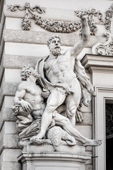 Austria, Vienna, Michaelerplatz: Big statue sculptures at the Michaelertrakt exterior wall facade of the famous Hofburg Palace in the city center of the Austrian capital - concept architecture art