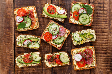 Sandwiches with cream cheese, vegetables and salami.
