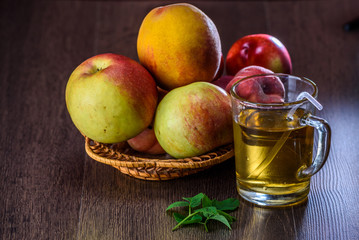 Still life of peaches and juice on a dark background