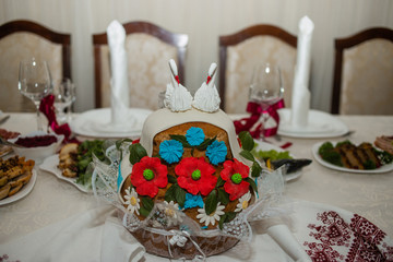 The top of the white cake is decorated with swans