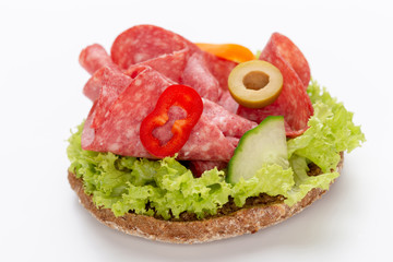 Sandwich with salami sausage on white background.