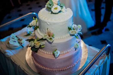 A savory wedding cake is decorated with flowers