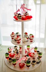 Candy bar. Sweet cakes on saucers