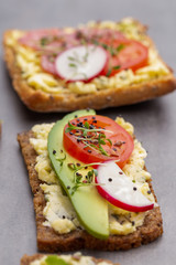 Sandwiches with cream cheese, vegetables and salami.