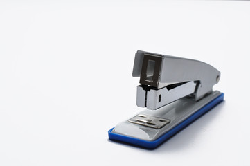 Big silver stapler is isolated on a white background