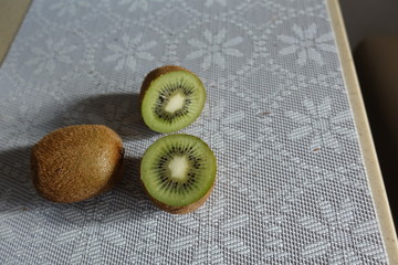 Fresh kiwi fruit on the table. Whole and cut