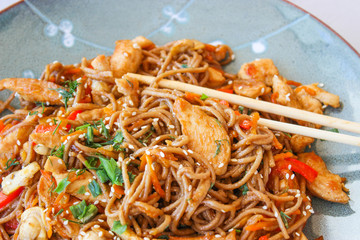 Buckwheat noodles with vegetables and chicken breast in the sauce teriyaki