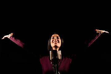 Portrait of woman recording a song in a professional studio