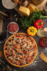 Pizza with minced meat, paprika and olives for the restaurant menu.