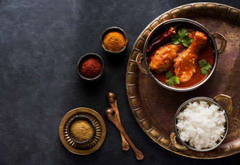 Indian dish Spicy Chicken Curry Masala. Spicy chicken legs with rice