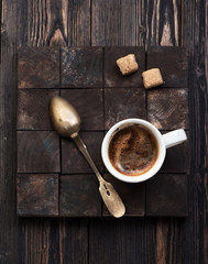 Cup coffee with sugar on a dark wooden background