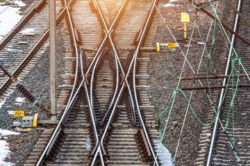 Industrial landscape with railroad tracks on concrete railway sleepers, arrows.