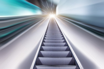 View escalator stairs rise to the top of the light, movement effect motion blur.