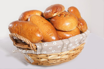 delicious pies in the basket. Side view on a white background with natural soft lighting.