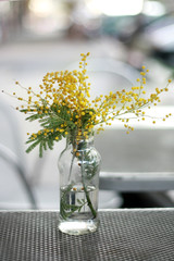 bouquet of flowers in vase on wooden table