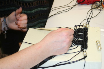 Women's hands weave macrame